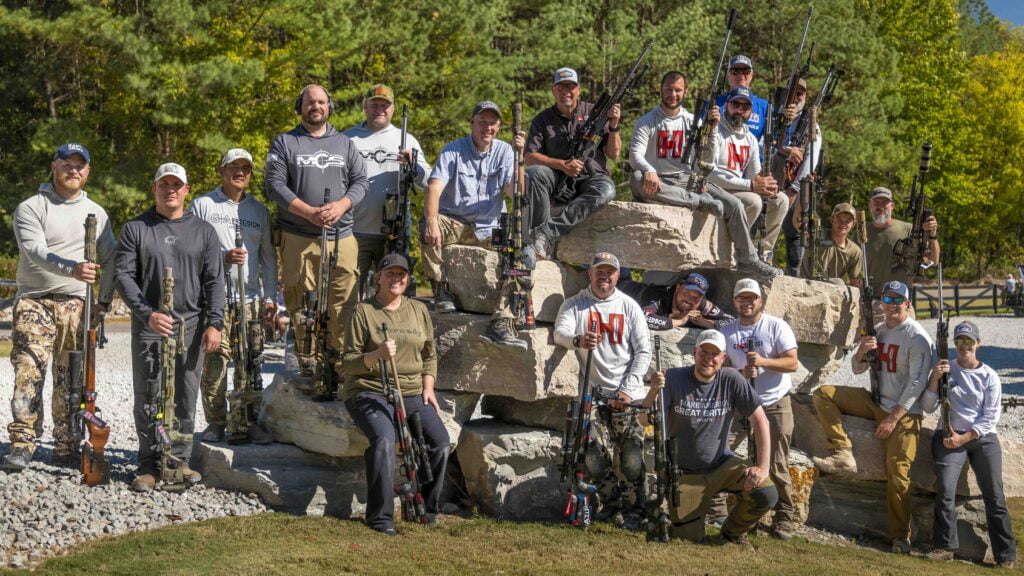 Big group of men posing for a group photo at a press event.